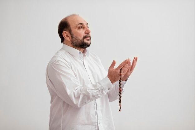 Free photo man praying on the floor indoors