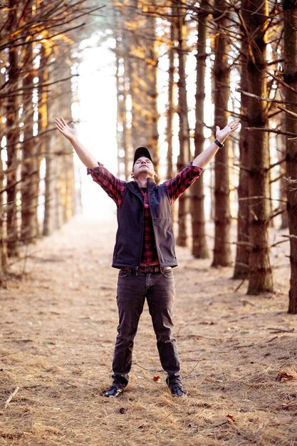 man praying in a forest