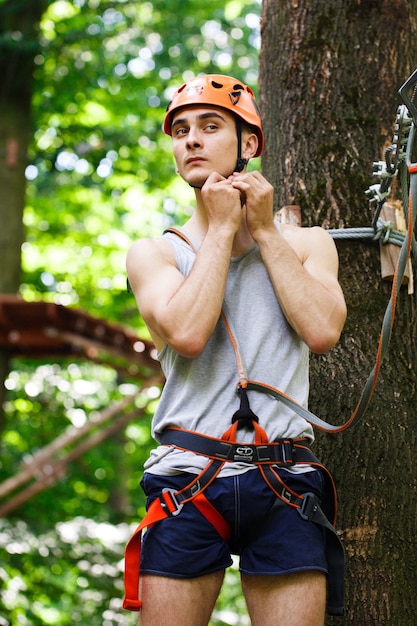 Man prepares to climb on the ropes in the park