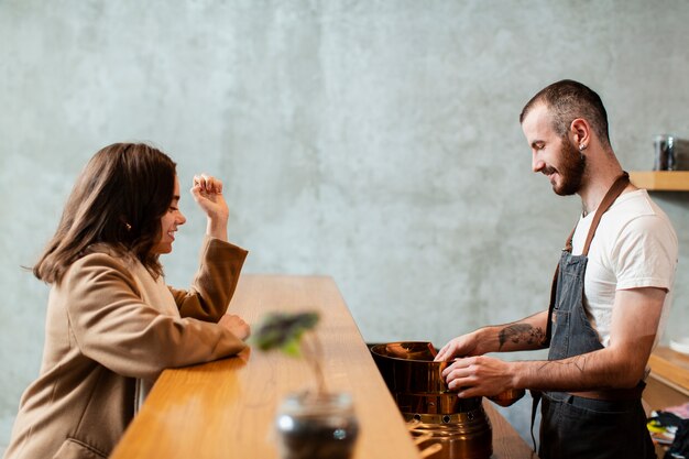 man preparing coffee to customer