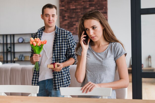 Man preparing presents for woman at home