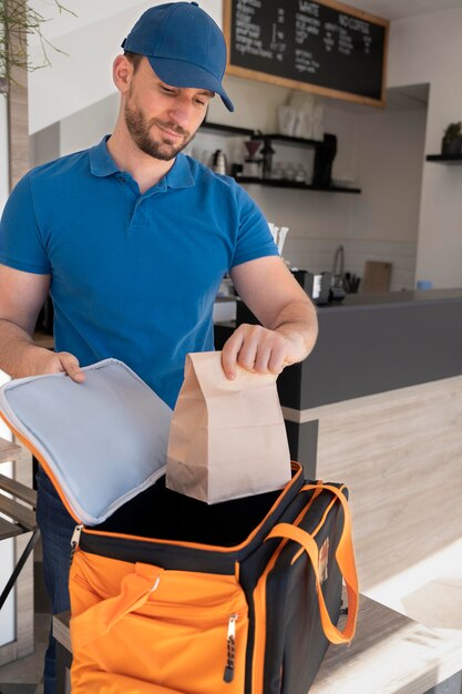 Man preparing takeaway food for delivery