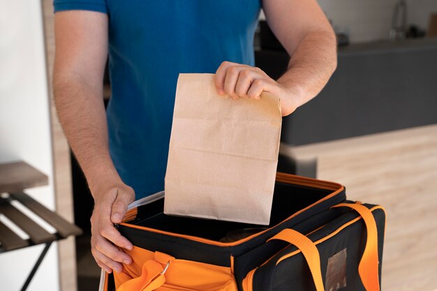 Man preparing takeaway food for delivery