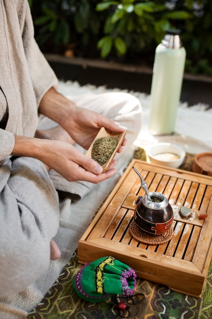 Free photo man preparing yerba mate side view