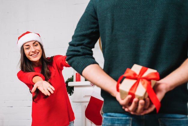 Man presenting gift for woman