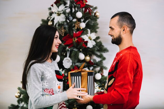 Man presenting gift to woman 