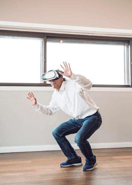 Man pretending to touch while wearing virtual reality headset