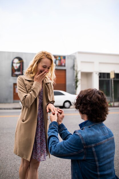 Man proposing to woman outdoors in the street