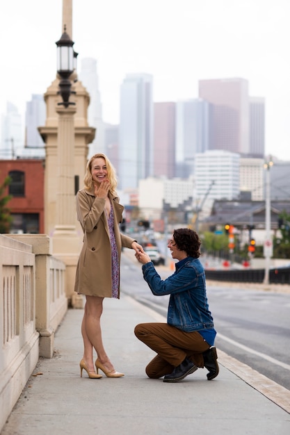 Man proposing to woman outdoors in the street