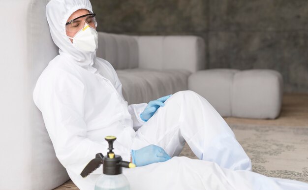 Man in protection suit sitting
