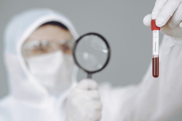 Free photo man in protective suit and glasses on grey wall