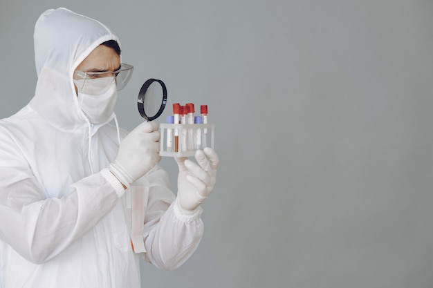 Man in protective suit and glasses working at laboratory