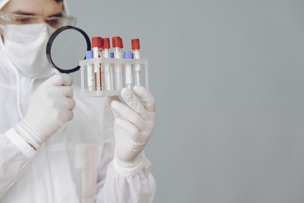 Man in protective suit and glasses working at laboratory