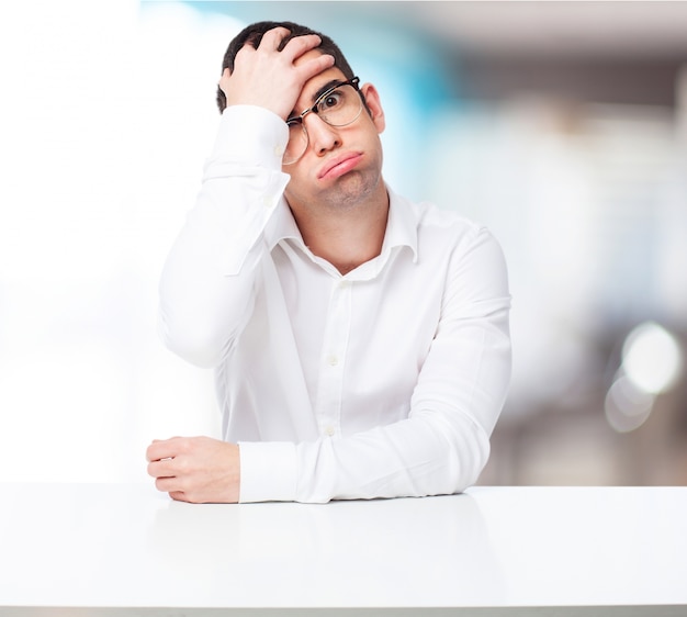 Man puffing with one hand on forehead