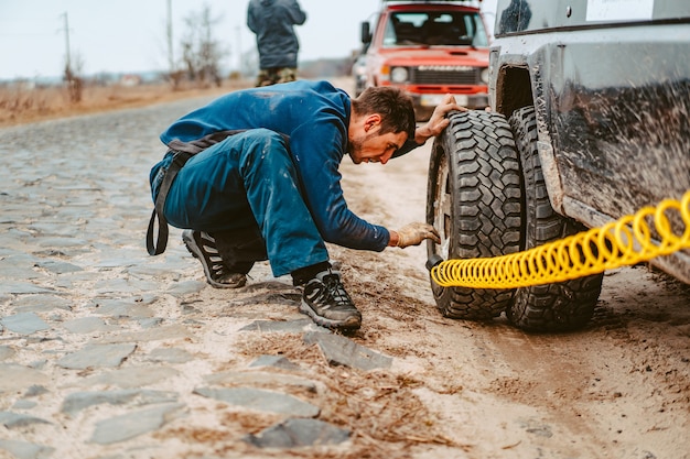 A man pumps air wheel with a compressor