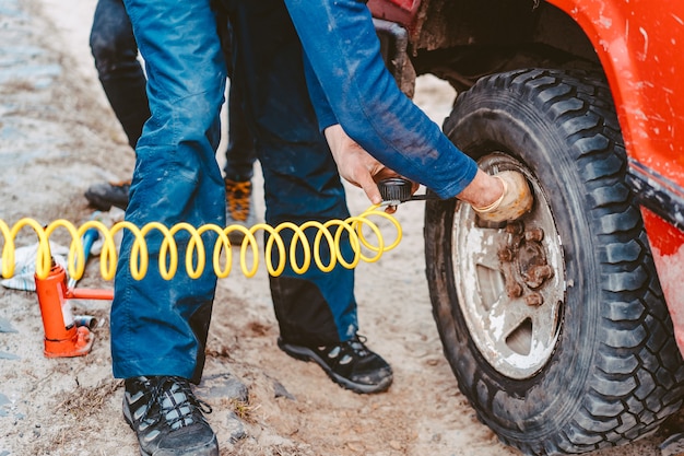 Man pumps air wheel with a compressor