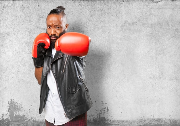 Man punching red boxing gloves