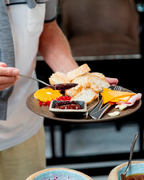 man puts some jam on his plate