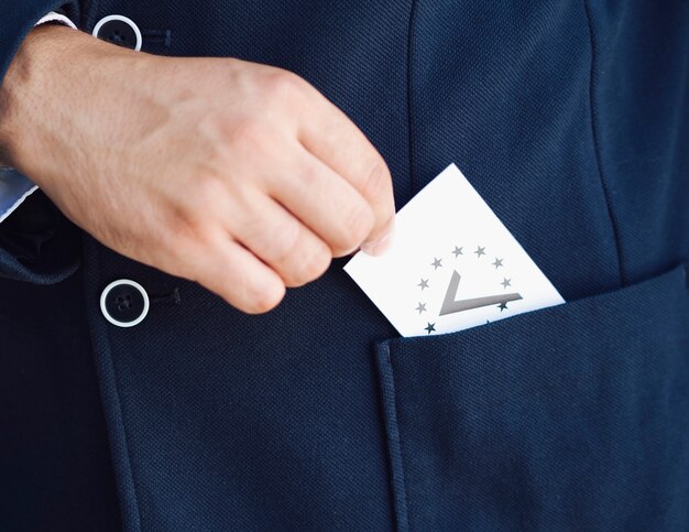 Man putting a ballot in his pocket 