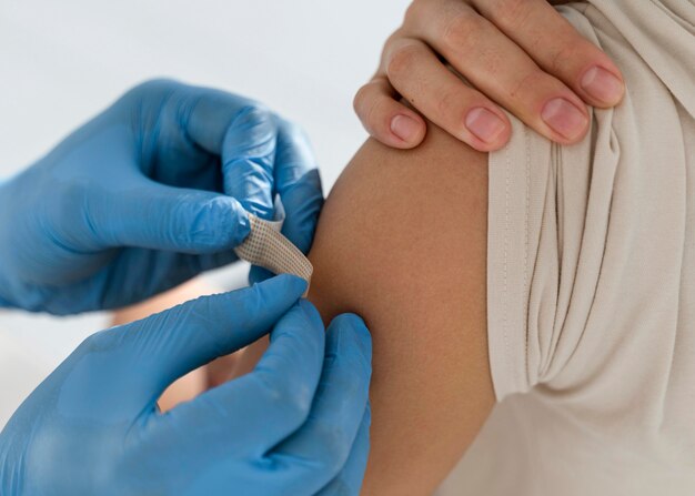 Man putting a bandage on a woman's arm