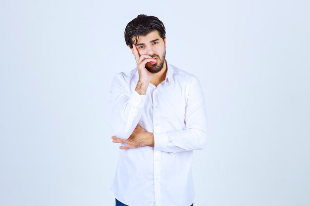 Man putting his hand to his chin and thinking