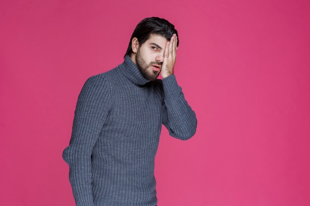 Man putting his head with hands as he made a big mistake or feels exhausted.