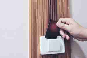 Free photo man putting key card switch in hotel room