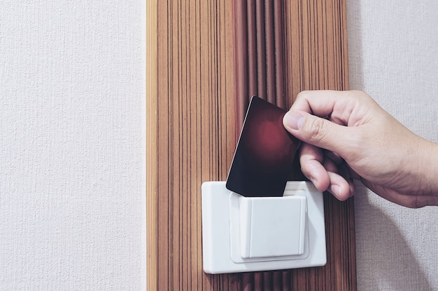 Man putting key card switch in hotel room