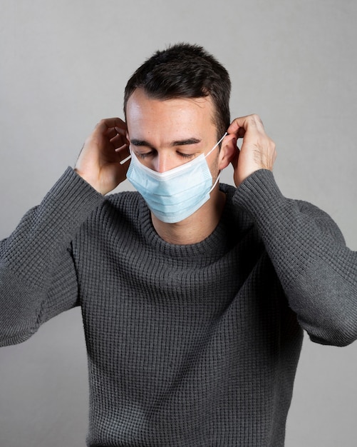 Man putting a medical mask on for protection