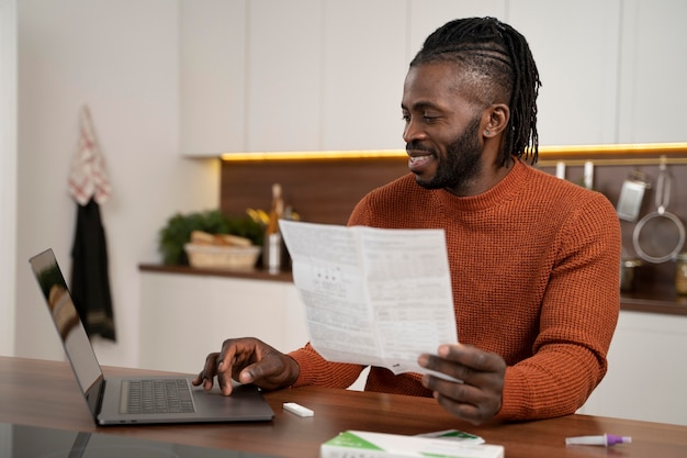 Free photo man reading the instructions for a covid test at home