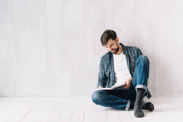 Man reading near wall