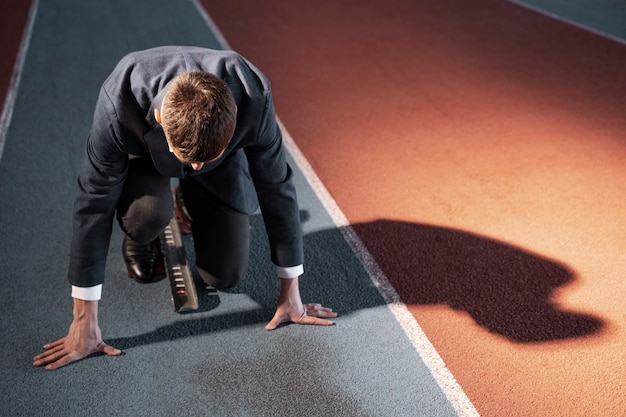 Man ready to run in suit full shot