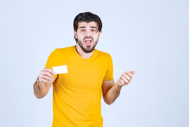 Man receiving the business card of a partner and getting confused.