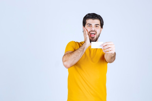 Man receiving the business card of a partner and getting surprised.