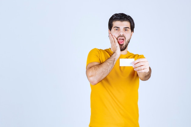 Man receiving the business card of a partner and getting surprised.