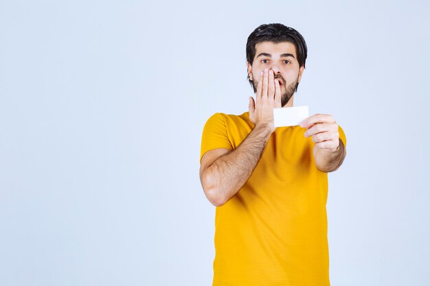 Man receiving the business card of a partner and getting surprised.