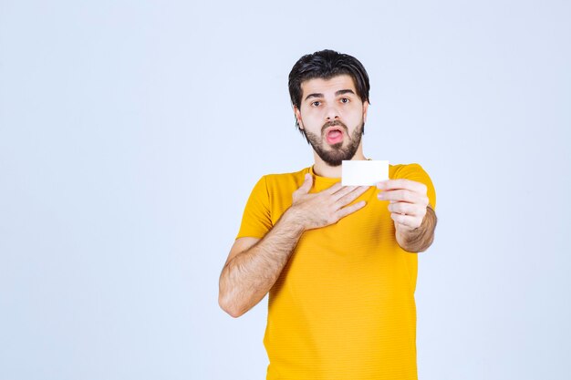 Man receiving the business card of a partner and getting surprised.