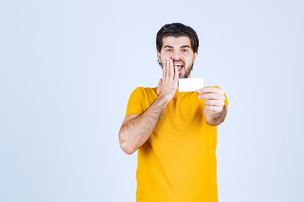 Man receiving the business card of a partner and getting surprised.