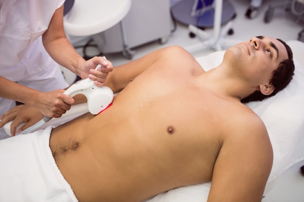 Man receiving laser hair removal treatment