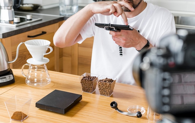 Free photo man recording coffee beans