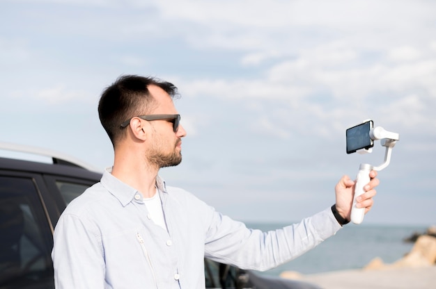 Man recording himself side view