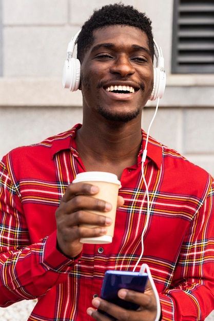 Man in red shirt holding a coffee