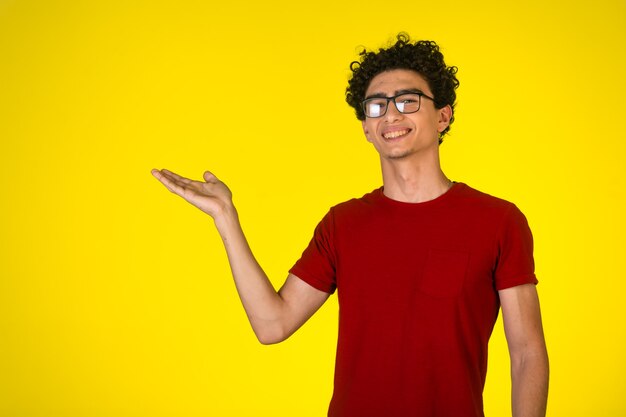 Man in red shirt making presentation with hand gest.