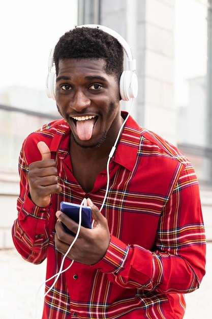 Man in red shirt sticking out his tongue