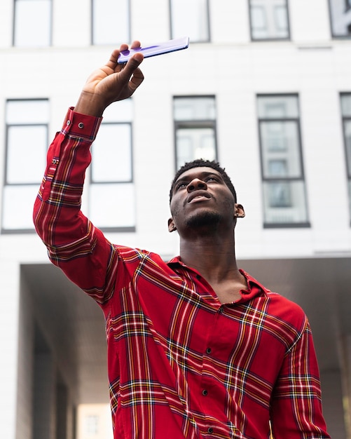 Free photo man in red shirt taking a selfie