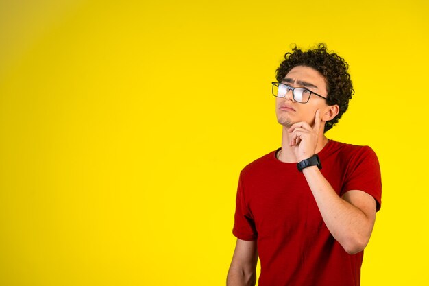 Man in red shirt thinking and planning. 