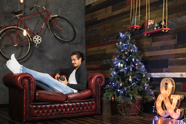 Man relaxing on couch at christmas