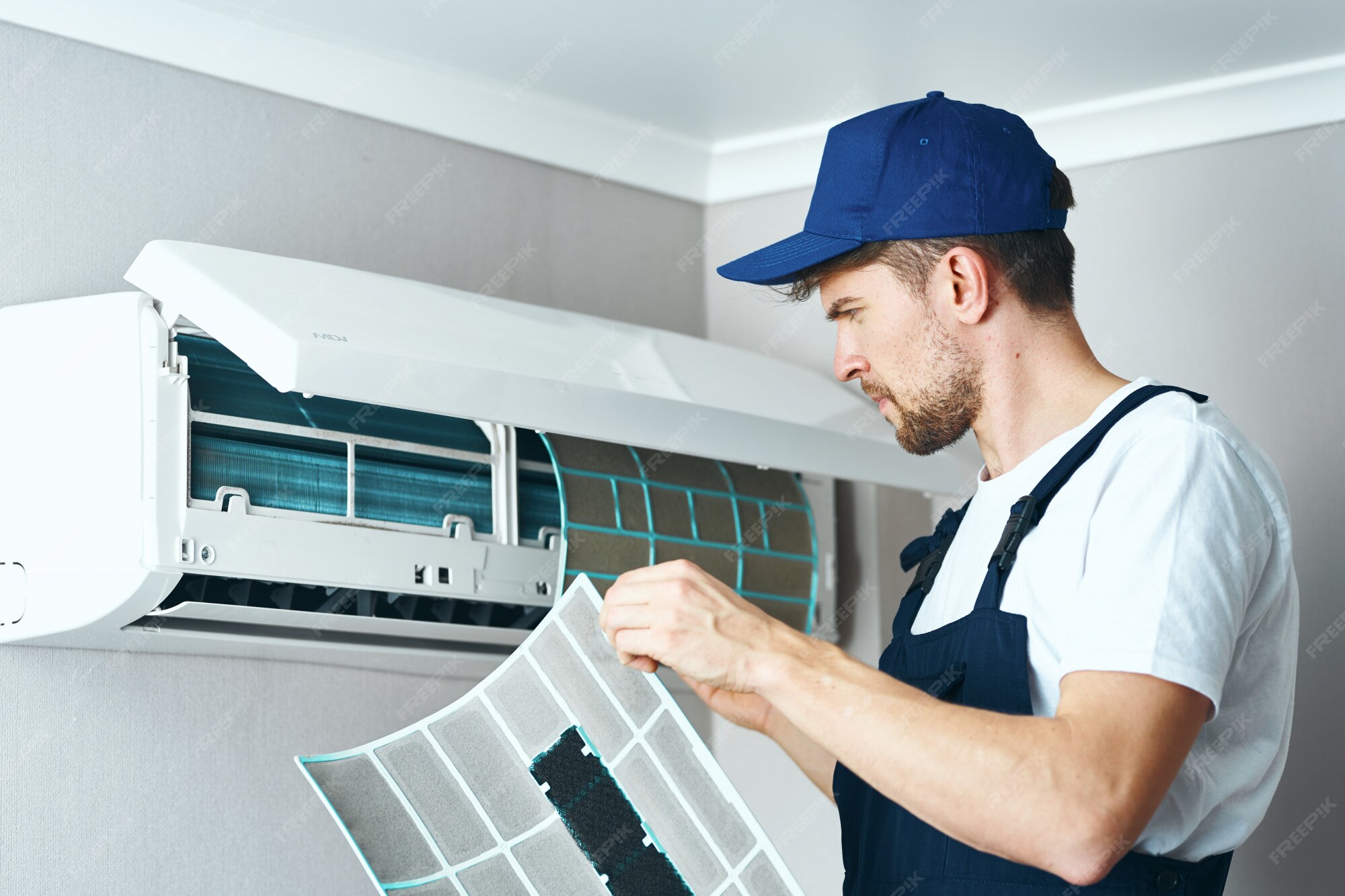 Premium Photo | Man repair and cleaning air conditioner, worker at home