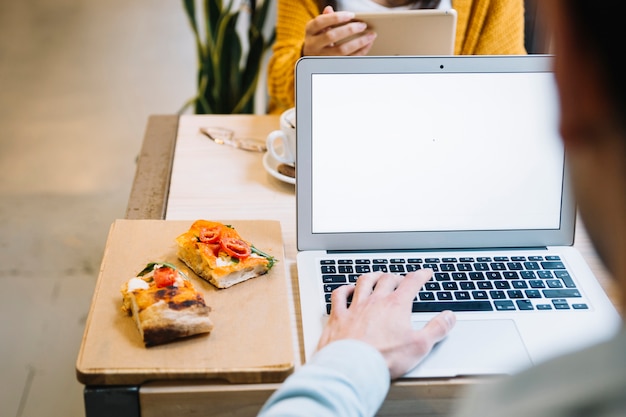 Man in restaurant concentrating on laptop