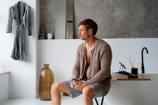 Man resting on seat with mug on his hands